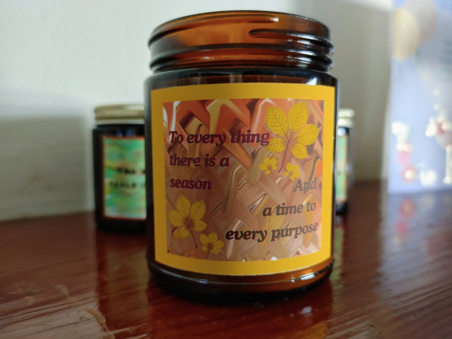 scented candles with 9 natural fragrance options in bronze glass jar and gold lid. Earthy color palettes and original designs with mindfulness quotes and imagery.