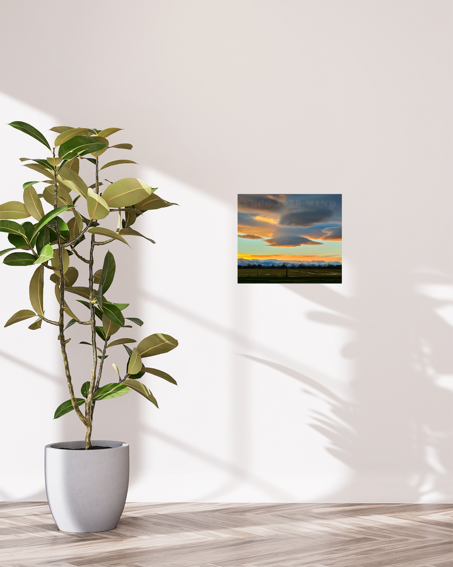 simple decor with radiant colorful snowcapped mountains with floating clouds and orange sunset hue