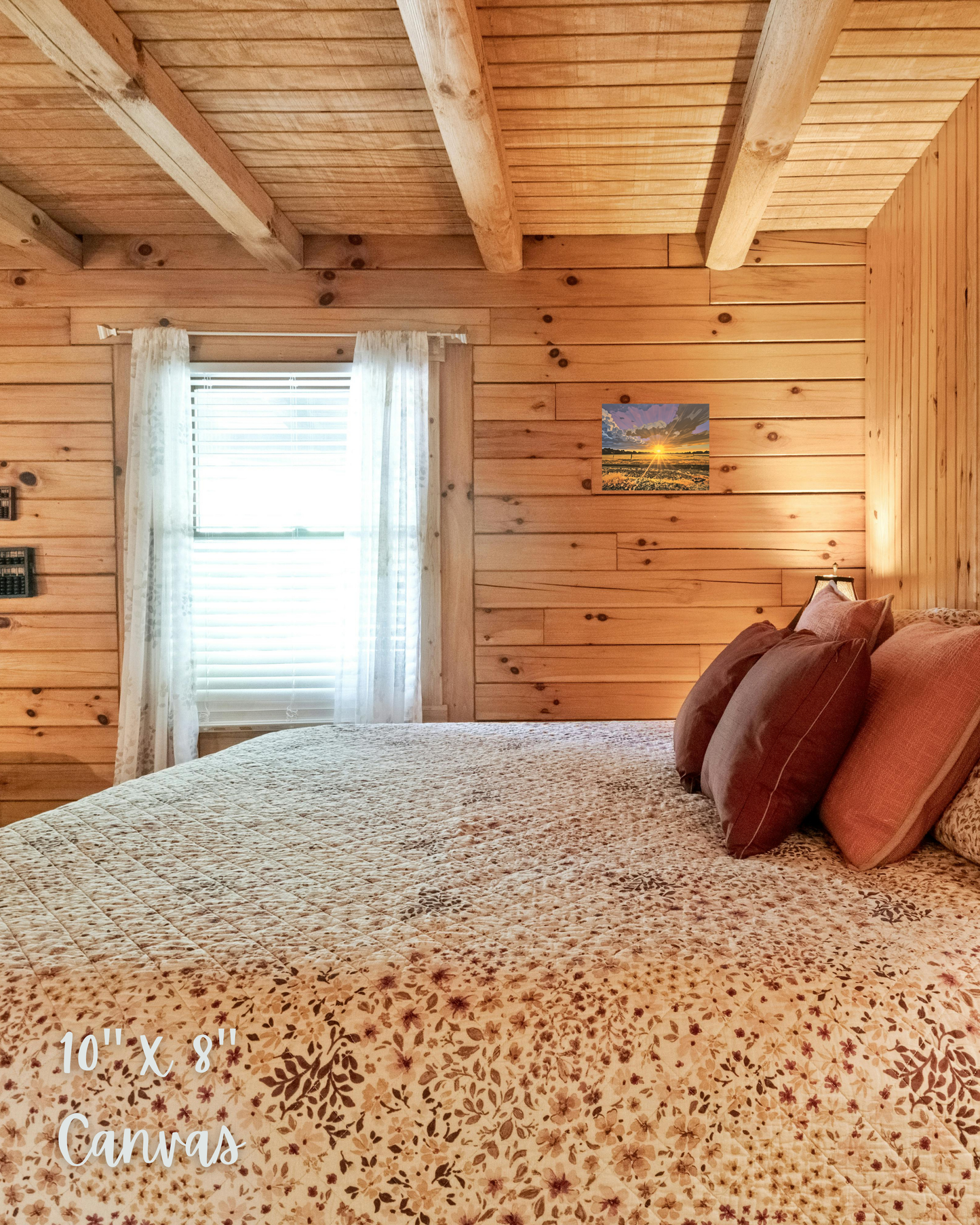 cabin bedroom with warm lighting and decor. features wall art with showing rural country sunset during golden hour with rangeland and purples skies