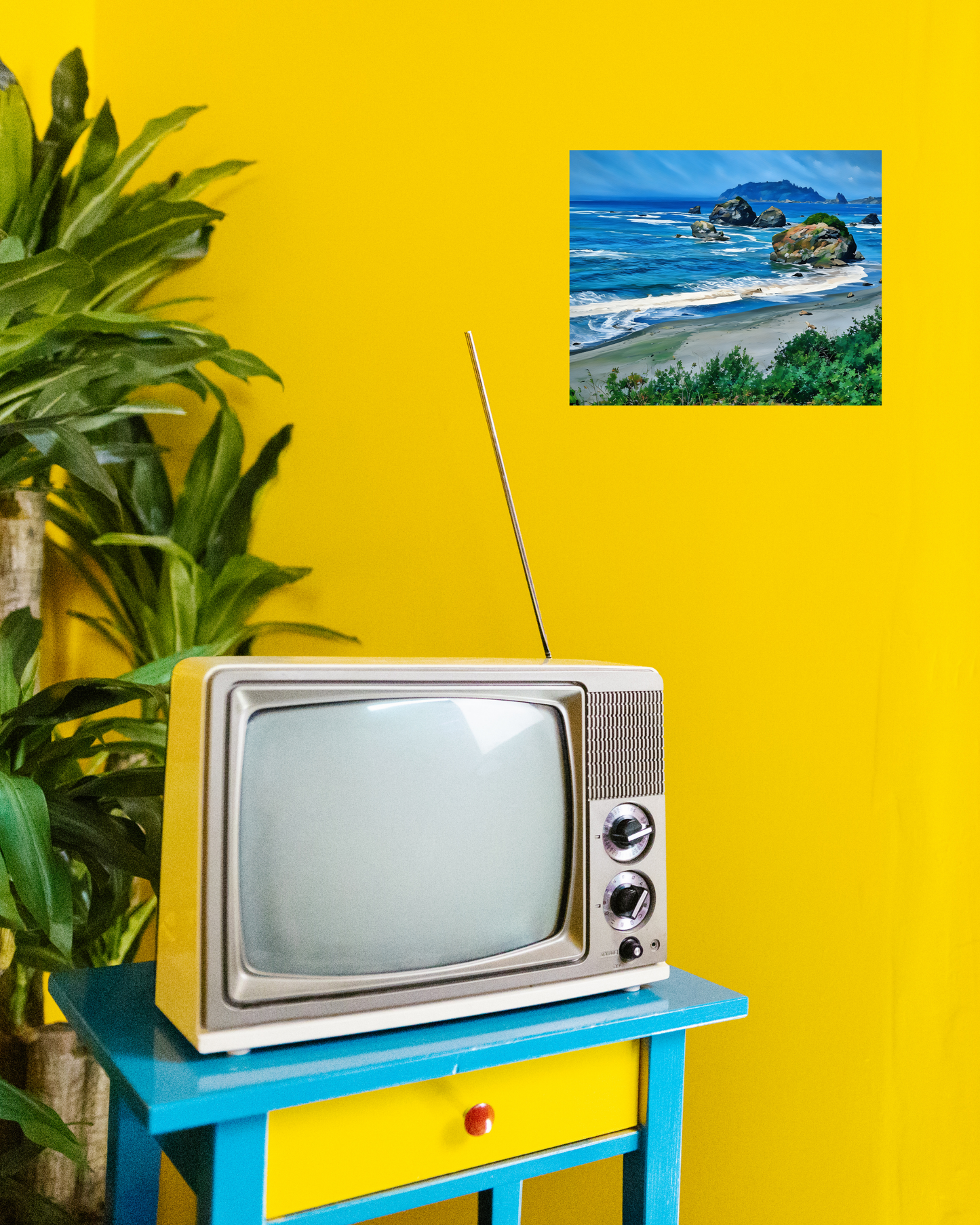 Vintage television on a blue stand with a yellow wall and vibrant ocean scene art print