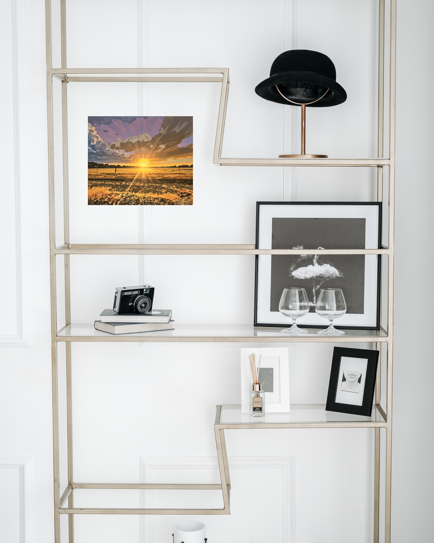 silver glass bookshelf with black and white classic decor juxtaposed by vibrant country sunset art with purple skies