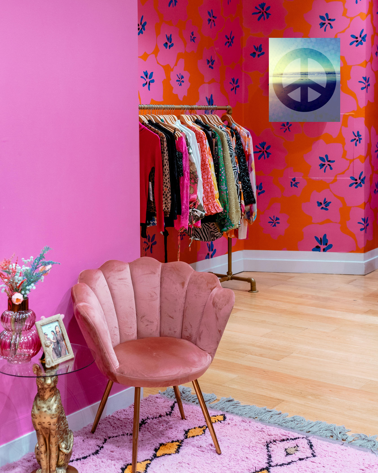 glamorous eclectic living space with peace sign artwork with blue hues and a wow ocean sunset backdrop