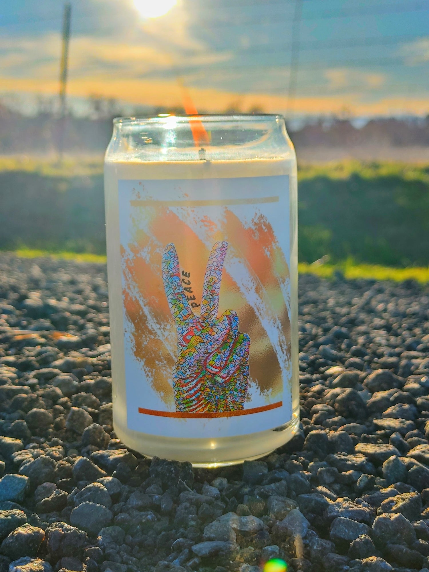 natural scented candle with long lasting burn in tall glass jar. Vibrant peace sign hand design in colorful mosaic style. Calm, relaxing, mindful candles.