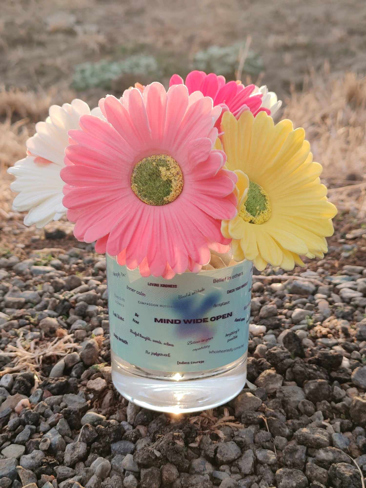 Relaxation candles with calming scents. Luxury candle with high quality natural soy wax and two wicks. Reusable glass, this photo depicts a repurposed candle vessel as a vase for daisies.