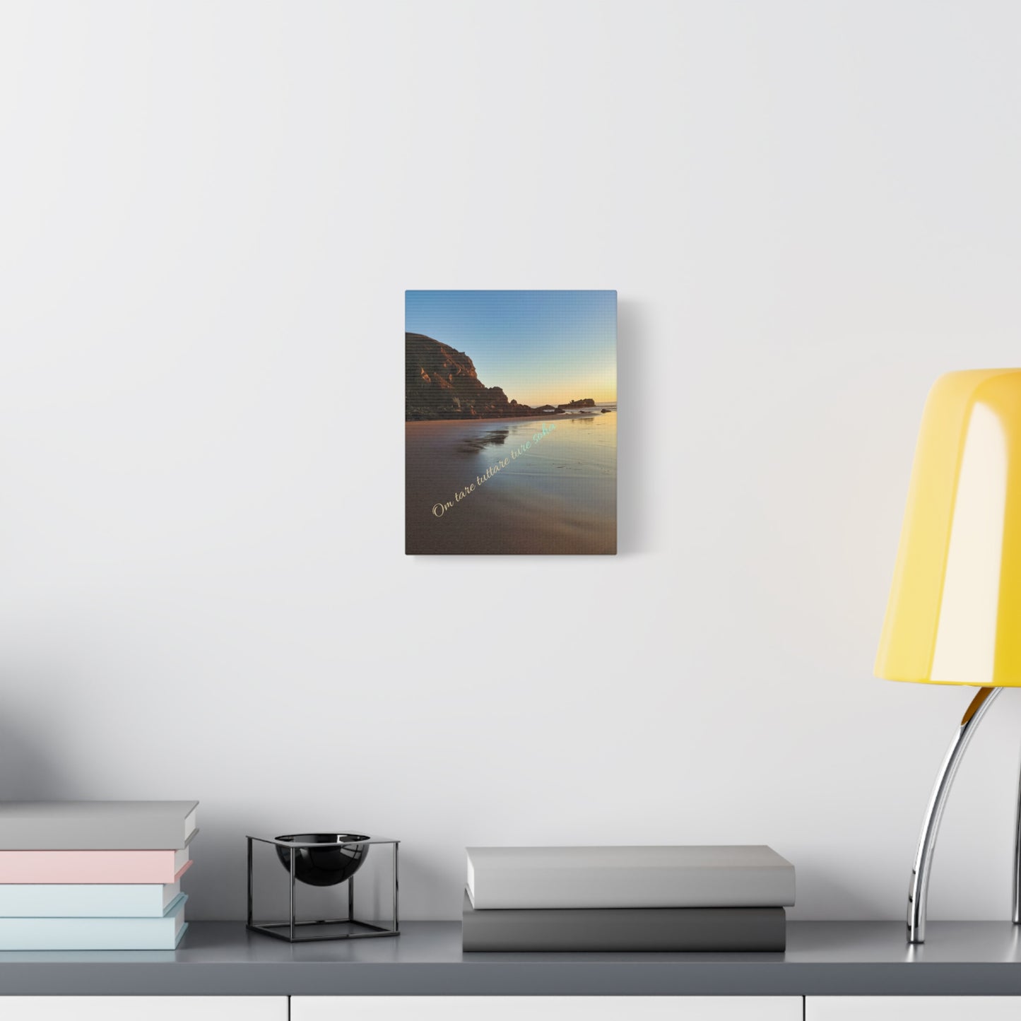 Canvas print featuring pacific ocean sand beach with rock motif and tibetan green tara mantra