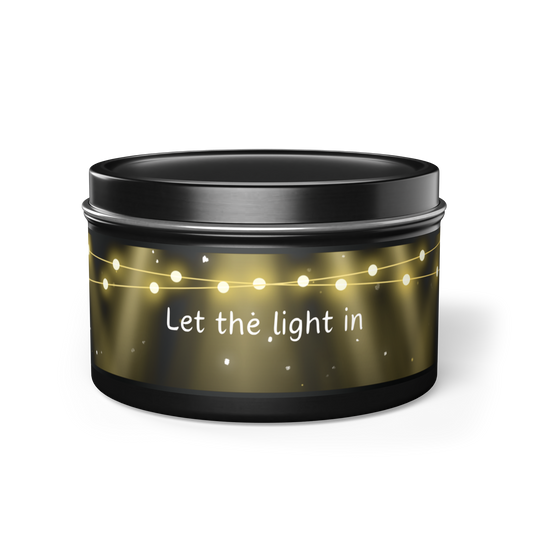 'let the light in' scented wellness candle in black container with original lighted design.