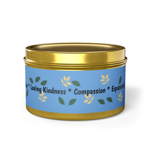 Scented candle, eco friendly, natural wax, in gold tin. Minimalist sky blue design with falling leaves and joy, compassion, equanimity, and loving kindness message.