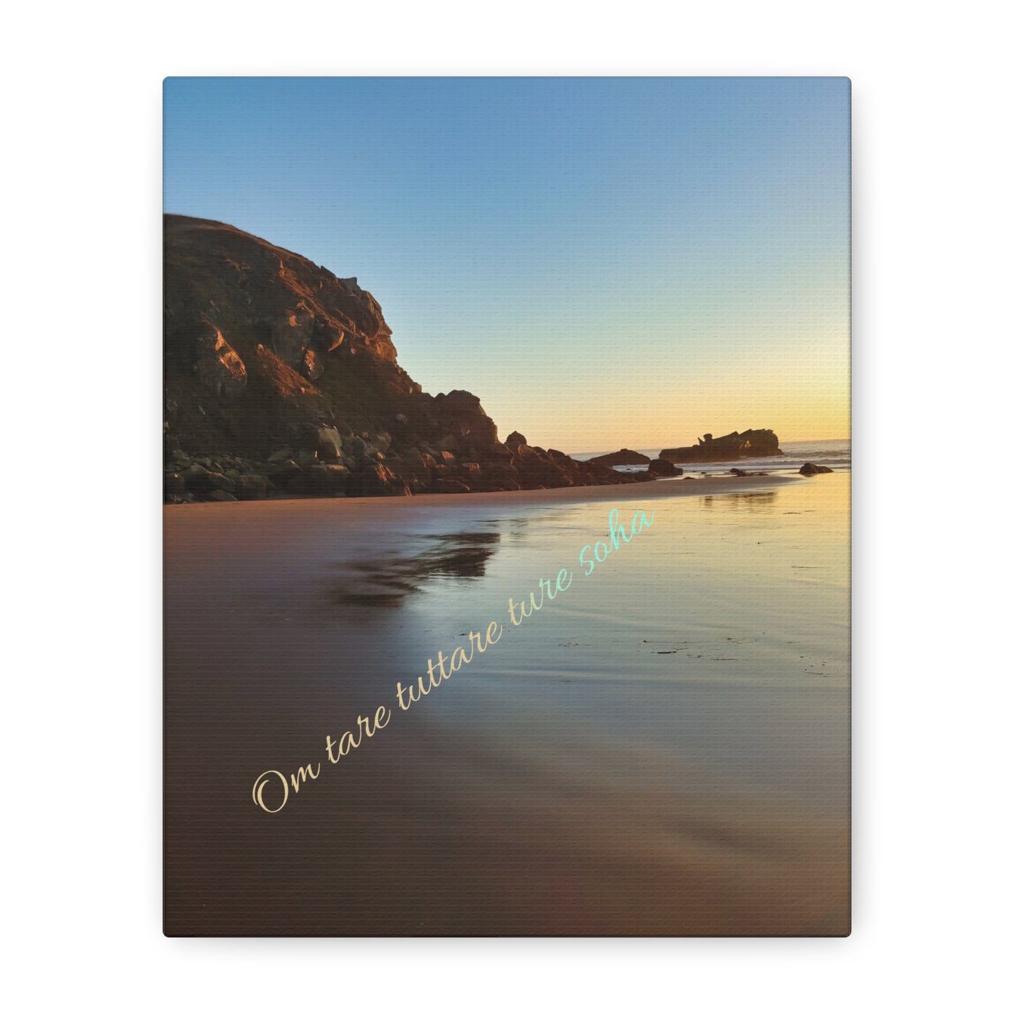 Beach scene with rock cliff at golden hour sunset. yellow, brown, blue tones, and compassion mantra written in sanskrit.