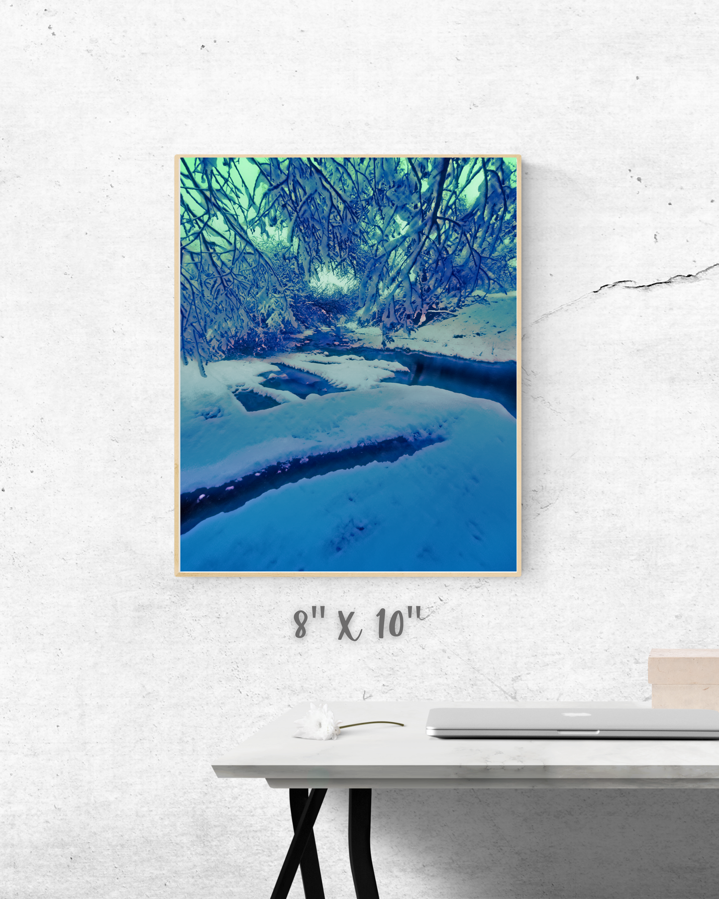 modern desk setup with winter wonderland art as a backdrop with glowing frozen creek picture