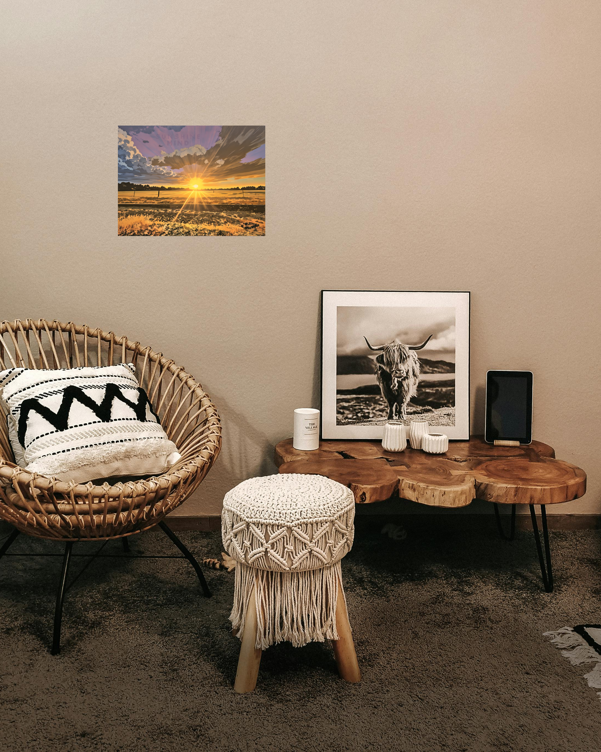 Western motif style living room with wicker chair, ottoman, wooden table, and golden sunset wall art.