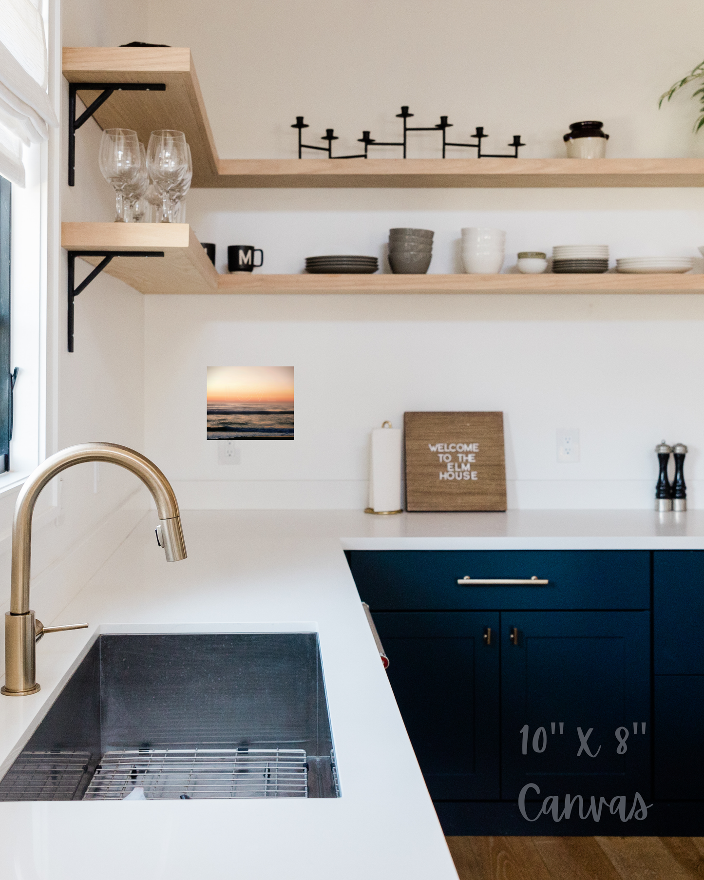 contemporary kitchen design with blue cabinets, open natural shelving, and dreamy ocean sunset wall canvas