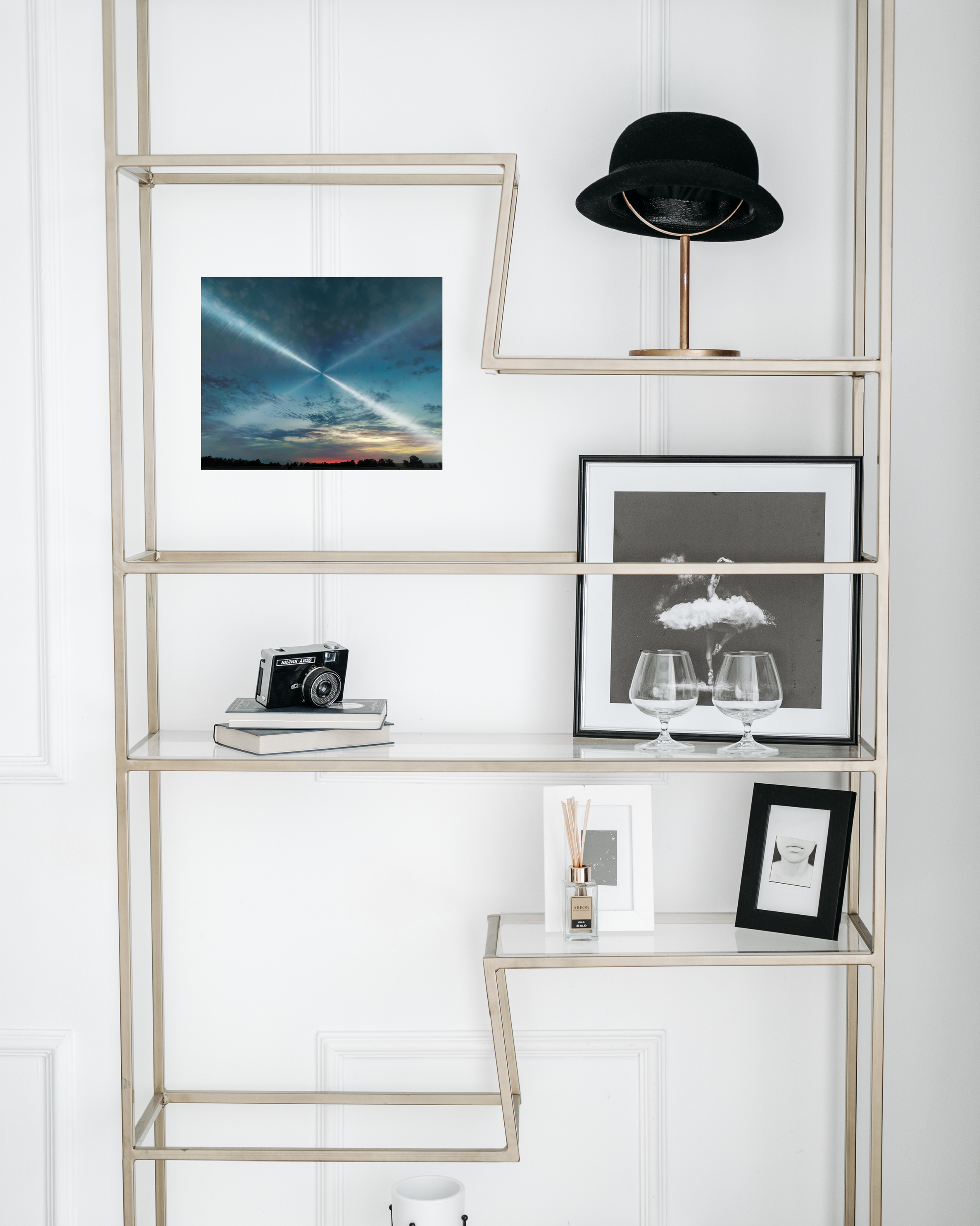 classic bookshelf with classic decor juxtaposed by radiant blue cloudscape view