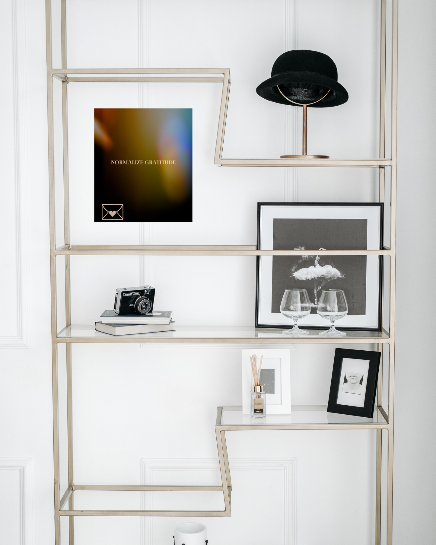 platinum glass bookshelf with chic touches and standout wall art with sending gratitude message and light leak design