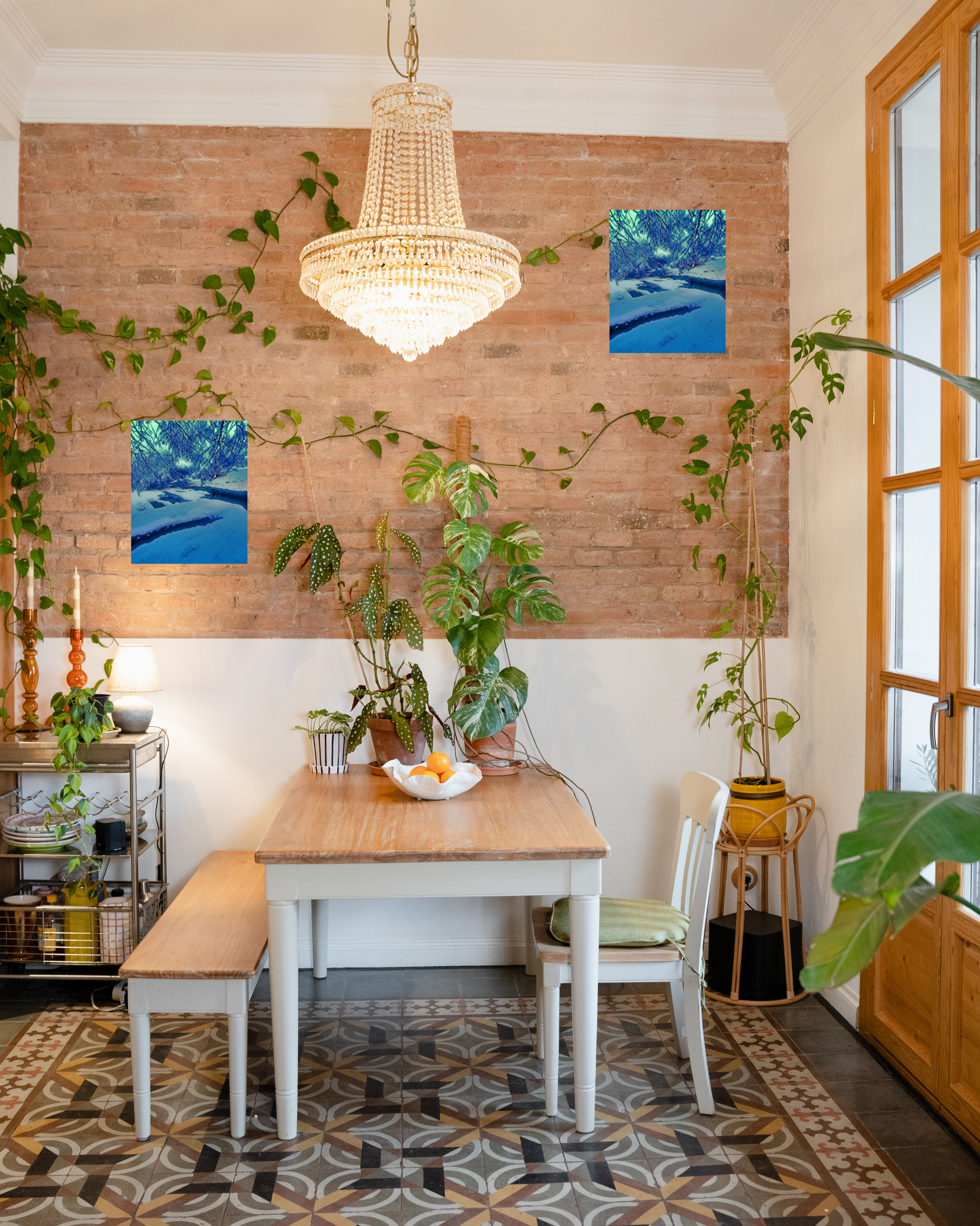 dining room nook with natural light lively plants and winter wonderland wall art set atop a brick wall