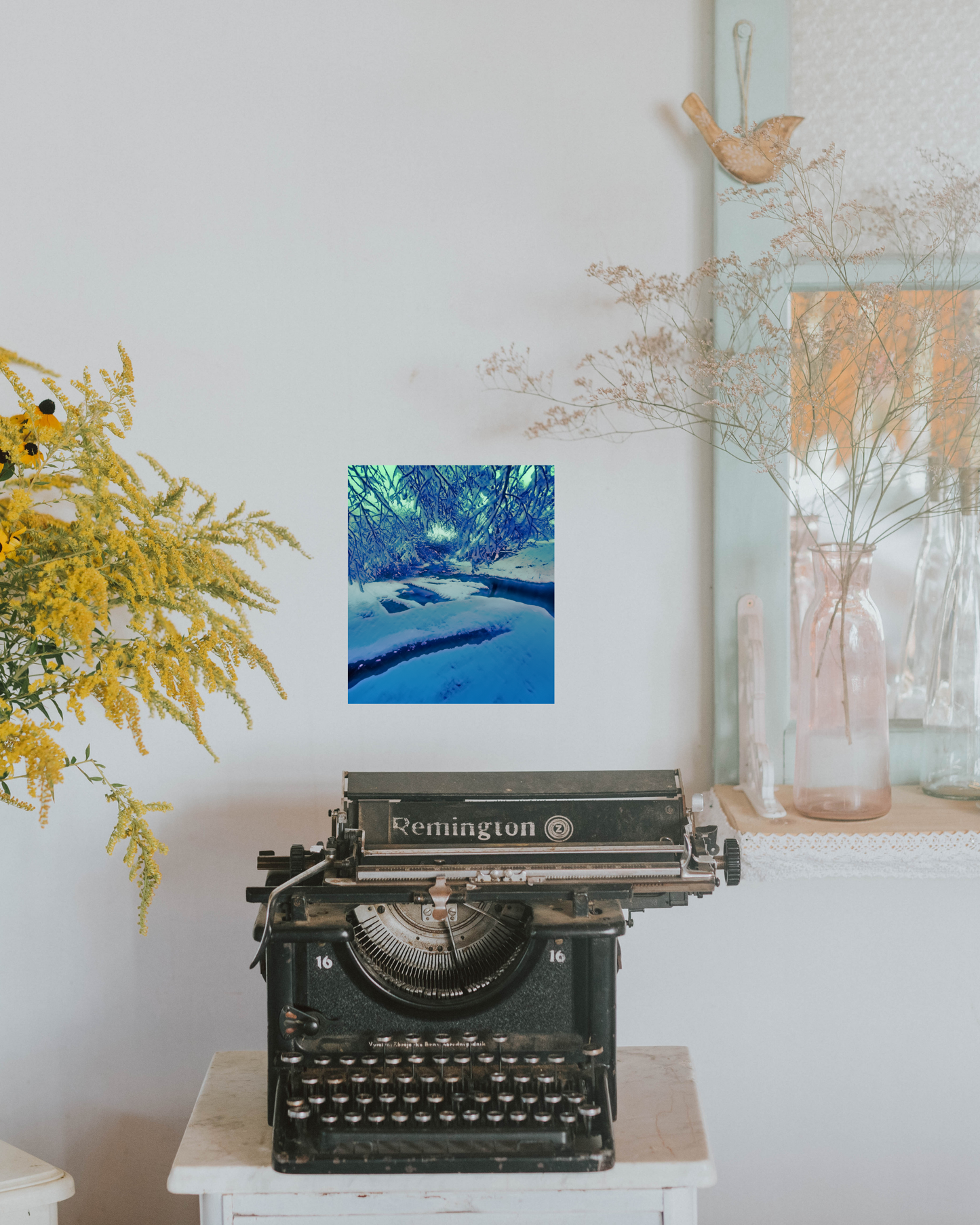 Shabby chic style room with a vintage typewriter and frozen winter nature themed wall decor