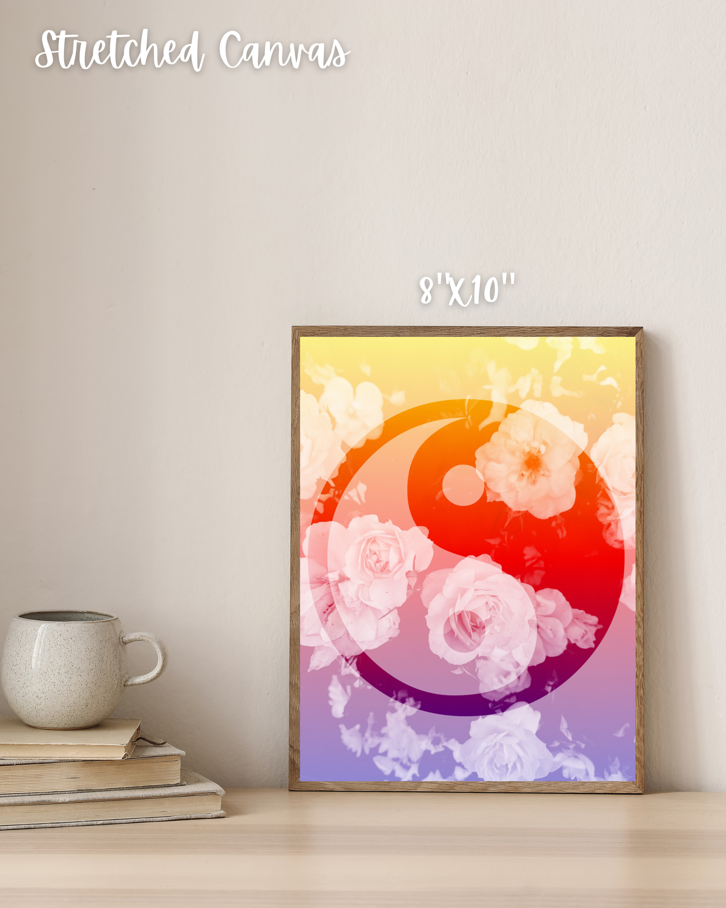 ying yang artwork with floral design and gradient colors on a wall above books and a mug.